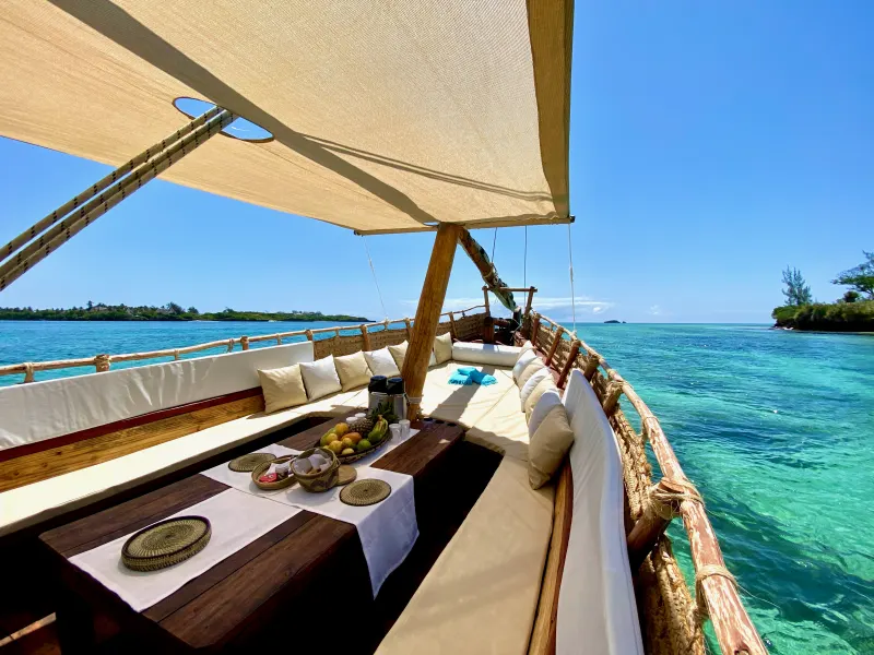 Cushioned lounge deck aboard the traditional dhow on turquoise water