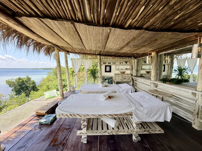 The Jua Spa treatment deck, open on every side, looking out over Mida Creek