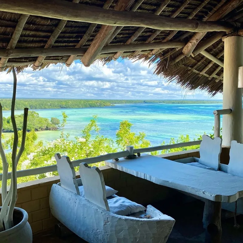 Handmade pasta with parmesan served against the bright turquoise water of the creek