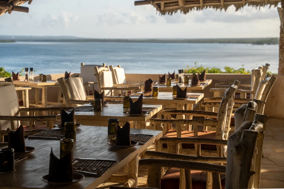 Tables set along the open terrace, looking out across Mida Creek towards the ocean