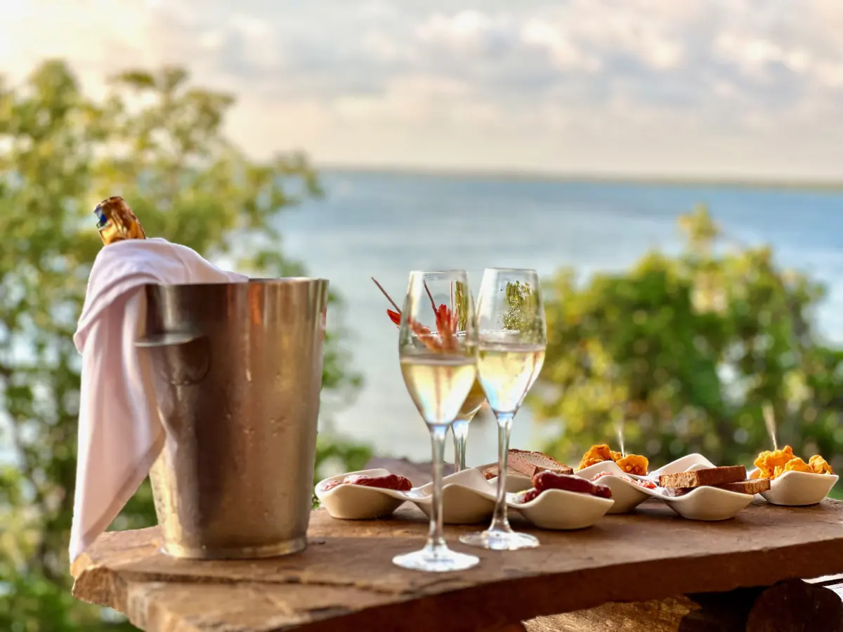 Champagne on ice and canapés laid out for a sunset aperitivo above the creek